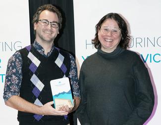 Chris Yeast receives the award for Service Excellence from VIU President Deb Saucier